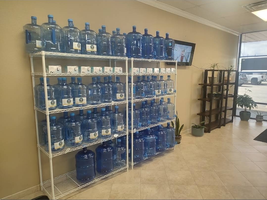 Shelves of filled five-gallon water jugs